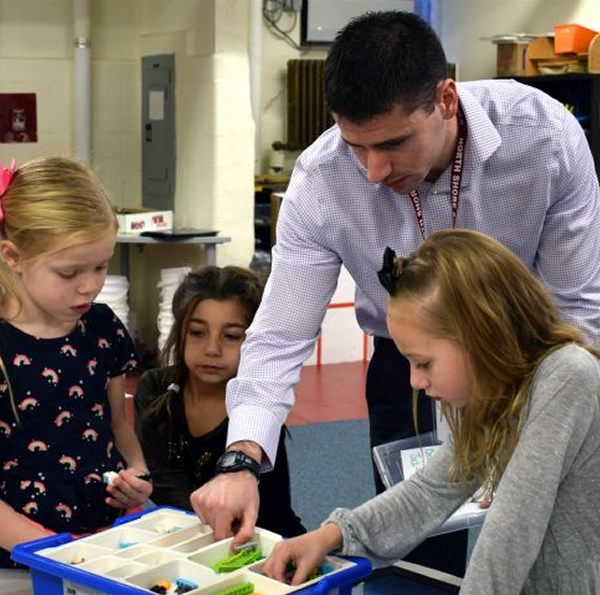 Teacher Assisting Students